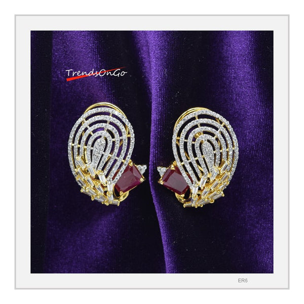 Gold Toned White Stone Earrings - Peacock shaped Studs has white American Diamonds & Red Gem