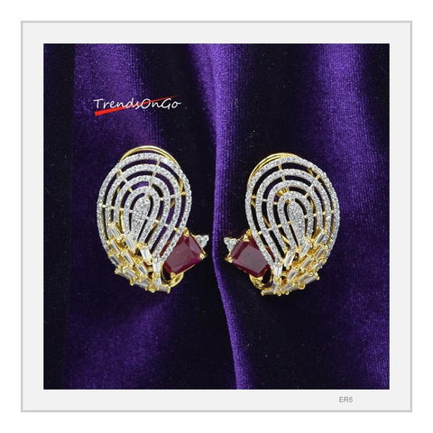 Gold Toned White Stone Earrings - Peacock shaped Studs has white American Diamonds & Red Gem